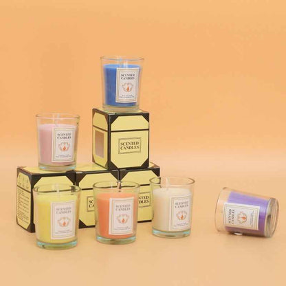 Delphy Valentine's Day scented candles in glass jars with yellow gift boxes, featuring pink, blue, yellow, orange, white, and purple fragrances for romantic occasions