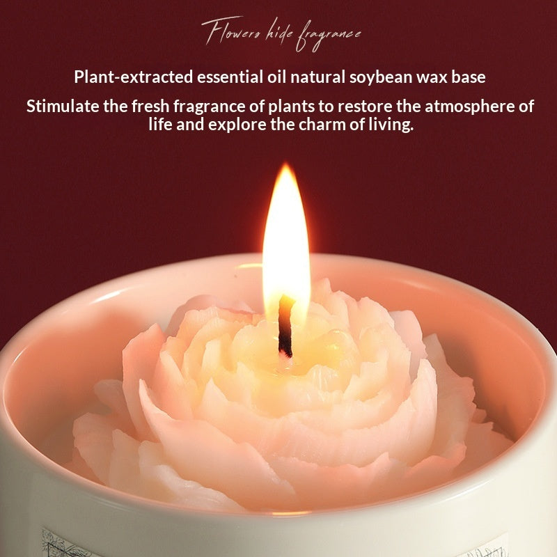 Close-up of a burning hand-carved camellia scented soy wax candle showcasing natural plant essential oil base and a warm glowing flame.