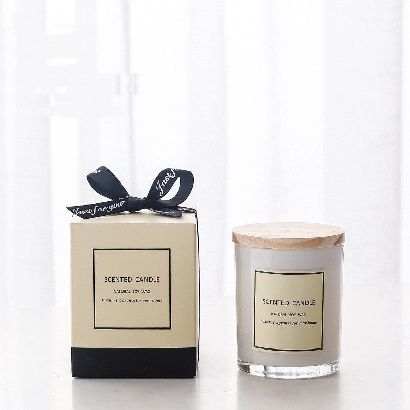 Delphy White Glass Soy Wax Candle in a glass jar with woody cover next to the packaging box.