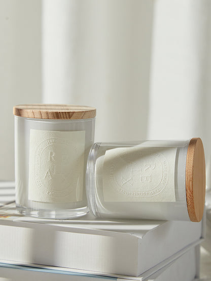 Elegant glass jar candles in different scents like Sandalwood and Misty Forest arranged on a vanity.