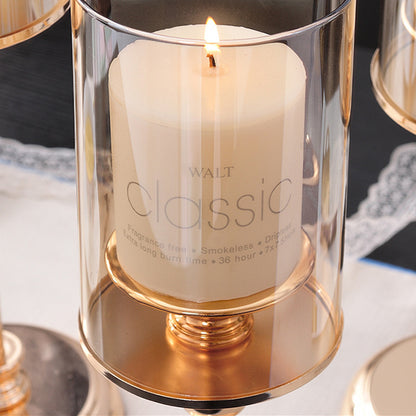 Delphy metal candle holder supporting a lit soy wax candle, creating a cozy and elegant atmosphere.