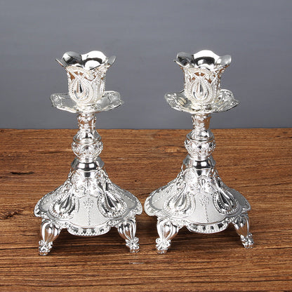 A matching pair of short gold tulip candle holders in zinc alloy, creating a romantic atmosphere for date nights.