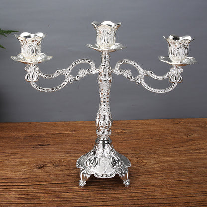 Elegant 3-arm silver zinc alloy candle holder featuring tulip-shaped candle cups and an embossed floral base.