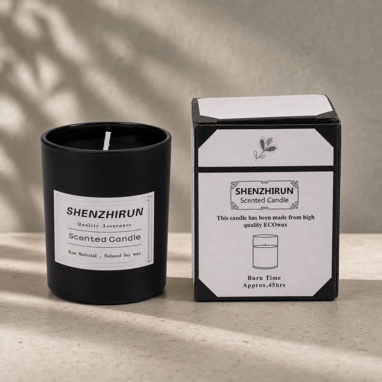 Black frosted Stress Relief Soy Candle in the large eight by seven centimetre cup beside its forty five hour packaging.
