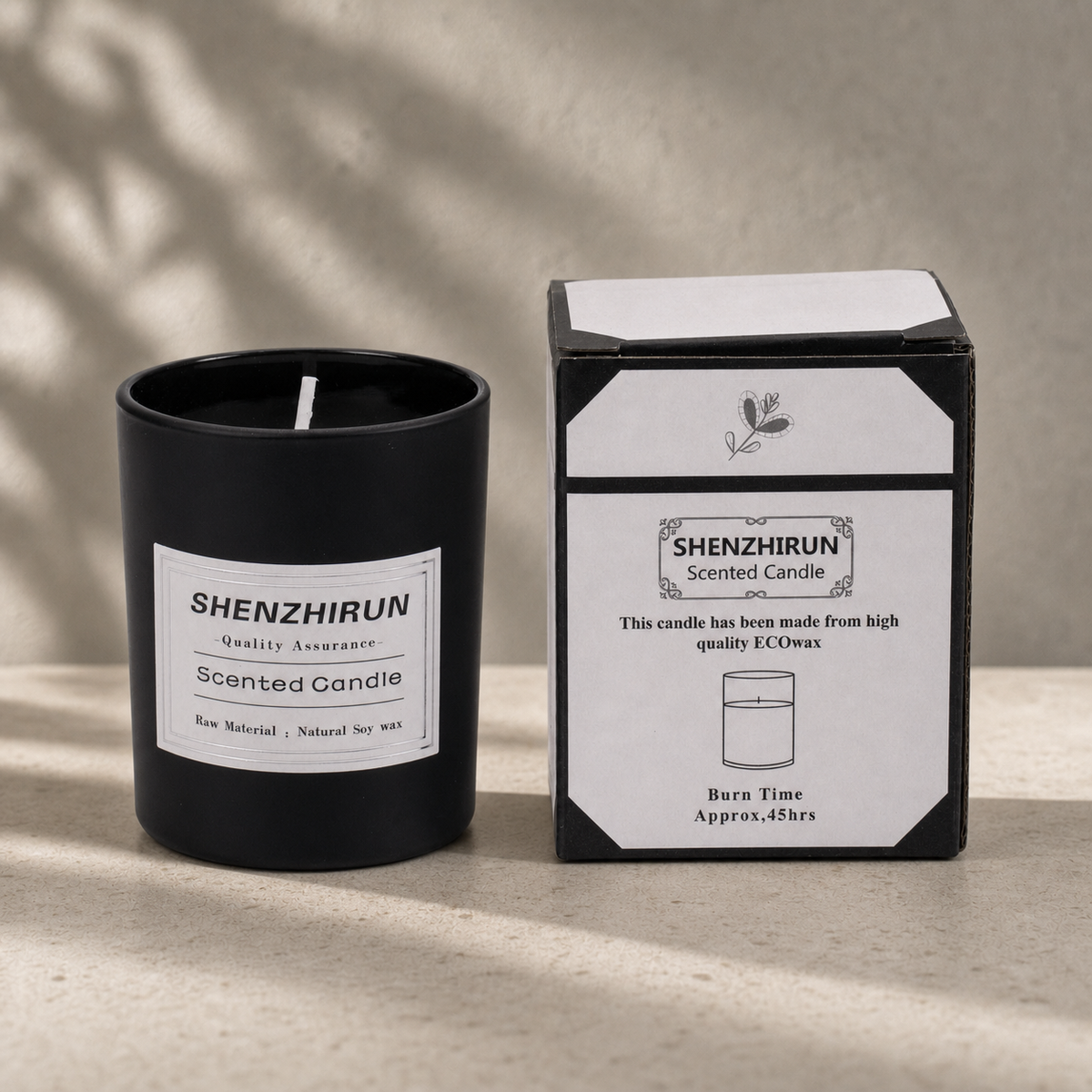 Black frosted Stress Relief Soy Candle in the large eight by seven centimetre cup beside its forty five hour packaging.